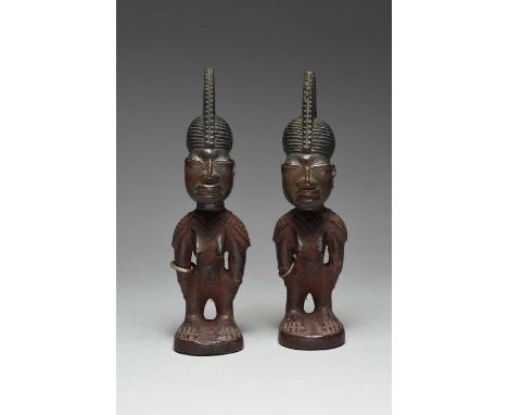 A pair of Yoruba female Ibeji figuresattributed to Oje, Ila Orangun, Igbomina, Nigeriawith ribbed, crested, pierced and notch