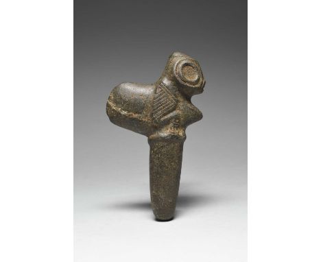 A Taino axe Greater Antilles, circa 1000 - 1500 AD stone, carved a zoomorphic creature with large round eyes, wings and talon