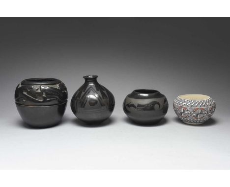 A Santa Clara blackware jarNew Mexicoof ovoid form with a relief carved encircling avanya with a matt painted mouth, the base