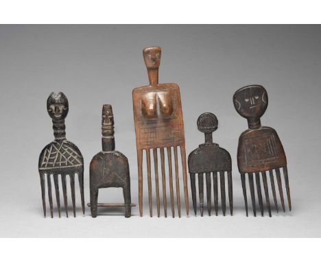Three Ashanti combsGhanathe largest carved a head and a pair of breasts, 22cm long, one with a flat head, 17cm long, and one 