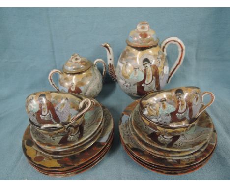 A vintage tea service in egg shell ceramic with hand decorated oriental design