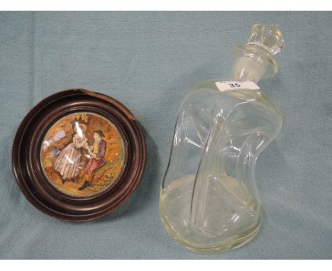 A vintage ceramic advertising jar lid and blown glass decanter of abstract form
