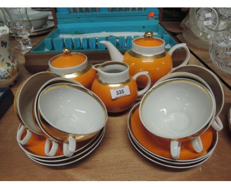 A retro part tea service in orange and gilt, 15 pieces