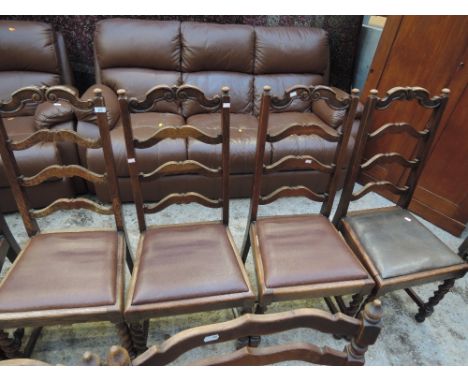 A set of 4 early 20th Century oak dining chairs having moustache ladder backs