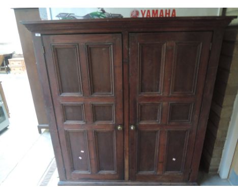 A 19th century stained panelled cupboard having shelf and drawer interior 