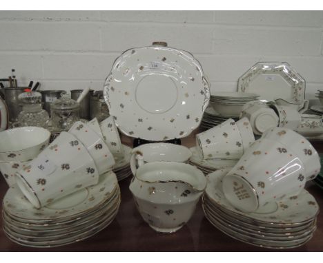 A vintage tea service by Imperial bone china with red fleck and gold design