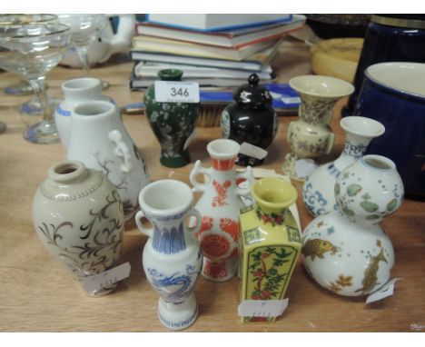 A selection of vintage ceramic miniature vases with oriental themes