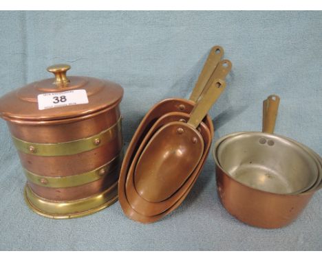 A selection of copper kitchen items including graduated scoop and cup sets also tea caddy