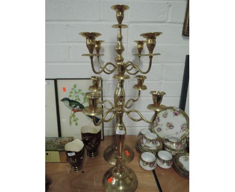 A selection of two graduated brass five stick candelabrum with a regal style  