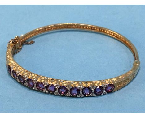 A 9ct gold amethyst and diamond bangle