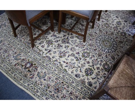 AN ORIENTAL CREAM GROUND SMALL CARPET with floral decoration within a banded boarder 350cm x 244cm