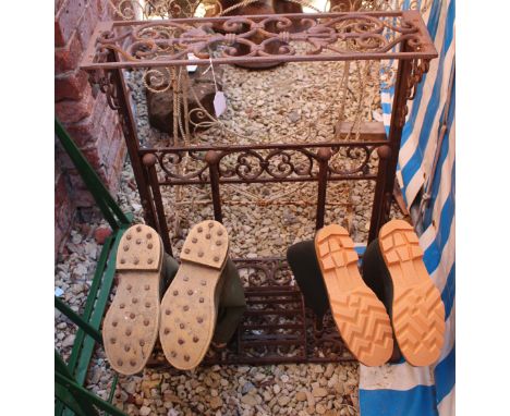 A VICTORIAN STYLE CAST IRON BOOT RACK with pierced scrolling decoration together with a pair of vintage Royal Hunter wellingt