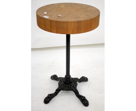 A CIRCULAR BUTCHERS BLOCK SIDE TABLE with black painted cast iron base 76cm tall