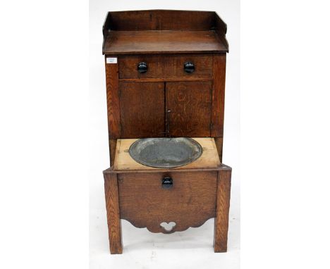 A 19TH CENTURY OAK NIGHT STAND with galleried top over single frieze drawer and all over cupboard, pull out commode drawer fi