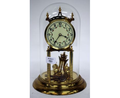 A GERMAN ANNIVERSARY CLOCK with turned finials, the enamel dial with Arabic numerals and floral swags, the movement under a g