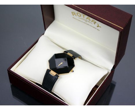 A ROTARY GOLD PLATED GENTLEMANS DRESS WATCH, facet cut octagonal face, the black dial with gold hands and sapphire inset wind