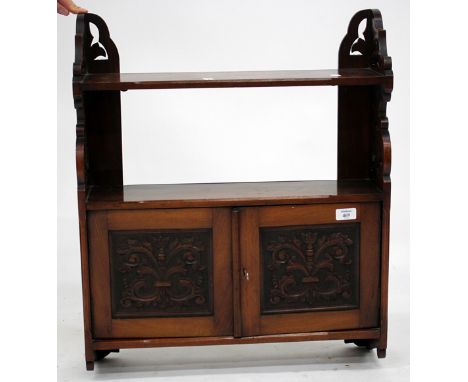 A VICTORIAN WALNUT HANGING WALL SHELF with pierced and carved supports and cupboard below, 57cm wide