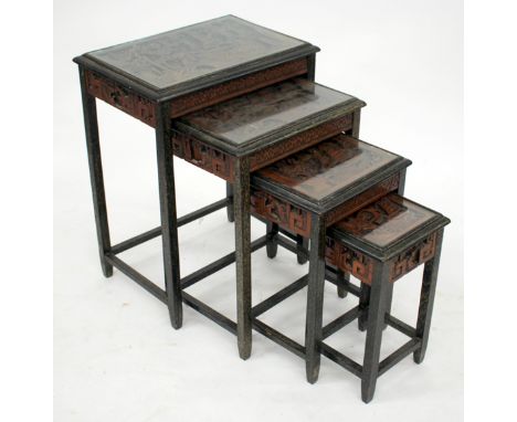 A NEST OF FOUR ORIENTAL CARVED WOOD OCCASIONAL TABLES with glass tops, the largest 50cm wide together with a Victorian circul