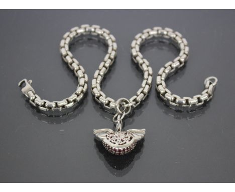 A SILVER CHAIN LINK NECKLACE BY THOMAS SABO with winged heart pendant set with ruby type stones 