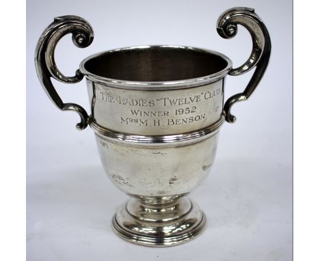 A SILVER TROPHY CUP with scrolling handle for the ladies 'Twelve' club winner, 1952, Mrs M.H. Benson 18cm high 