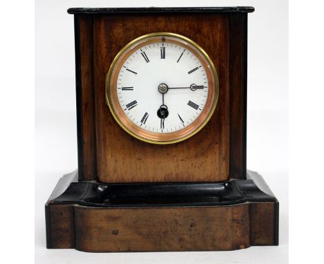 AN EARLY 20TH CENTURY WALNUT EBONISED MANTLE TIMEPIECE with a white enamel dial with black Roman numerals, 22cm tall overall