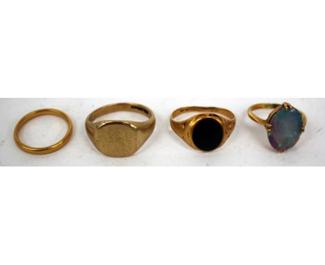 A 22 CARAT GOLD WEDDING BAND, 9 carat gold signet ring, an 18 carat gold opal set ring and a further gold ring (4)
