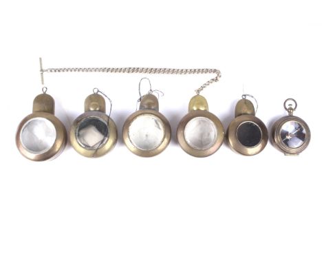 Five brass miners pocket watch cases and a similar compass. Four of the cases having bevelled glass panels, one stamped Regis