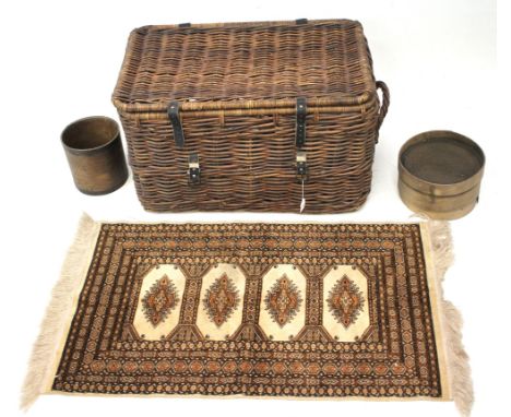 A vintage wicker two handled laundry hamper and other items. The hamper measuring L75cm x D46cm x H46cm and containing a rug,