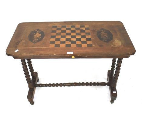 A Victorian mahogany games side table the top set with an inlaid chess board. Raised on bobbin turned supports and stretcher,