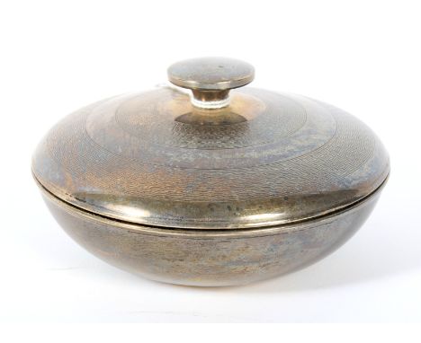 A 1930s Art Deco silver lidded pot. Of circular form, with engine turned decoration to the lid, Bakelite lined, hallmarked Bi
