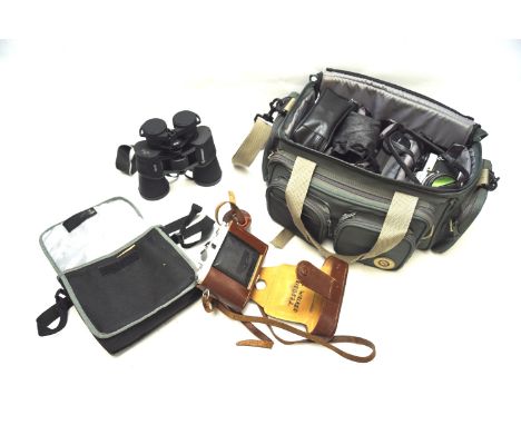 An assortment of cameras and accessories. Including an Olympus OM10 35mm SLR camera with 50mm 1:1.8 lens, a pair of Bresser 1