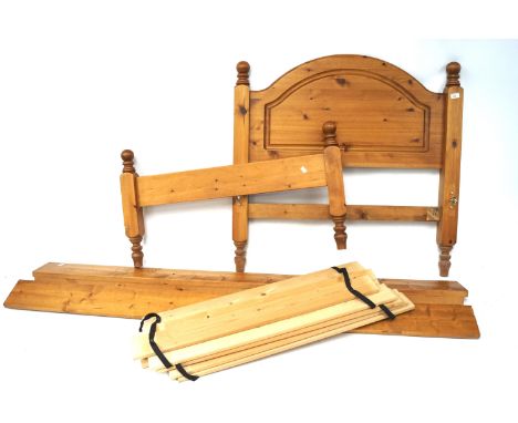 A contemporary pine single bed. With turned bed post finials, together with slats, unassembled, approximate size, L195cm x D1
