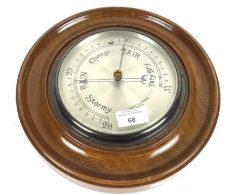 A circular wooden framed Negretti &amp; Zambra London wall barometer. Numbered R/2001, 29cm diam