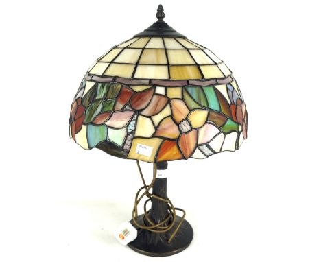 A 20th century Tiffany style table lamp with leaded glass shade. The lamp base itself in the form of a naturalistic tree, mea