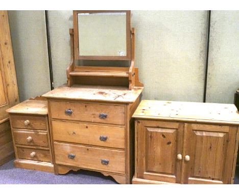 A pine dressing table, bedside cabinet and a TV cabinet. The bedside table with three single drawers on a plinth base, L46cm 