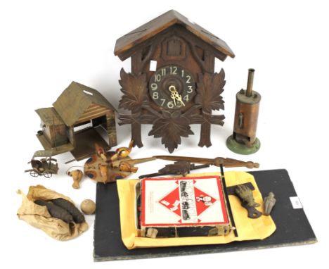 A box of assorted collectables. Including a metal automaton of a car entering a garage, cuckoo clock, Burnac steam engine, et