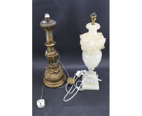 A cream alabaster table lamp and a gilt wood example. Both carved with leaves. Maximum height to fitting 49cm