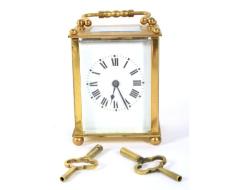 An early 20th century French brass cased carriage clock. The enamel dial with Roman numerals denoting hours, movement stamped