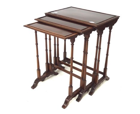 A nest of three mahogany occasional tables. Of rectangular form, all with inlaid details to the edges, raised on turned suppo