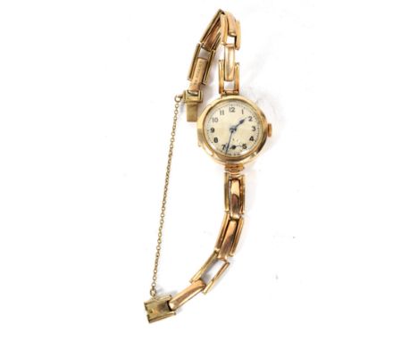 An early 20th century 9ct gold wristwatch. The dial with Arabic numerals denoting hours, 15 jewel manual wind movement, case 