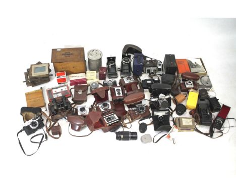 Large collection of vintage cameras and photographic items. Including items by Kodak, Praktika, Edixa, etc. 