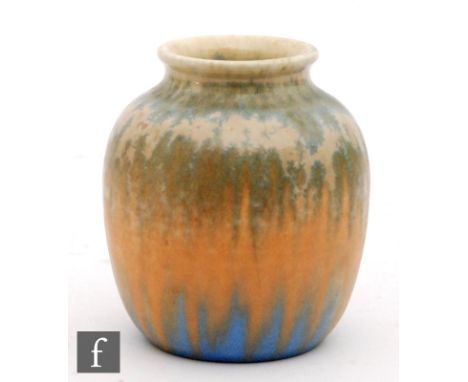 A small Ruskin Pottery vase decorated in a crystalline glaze with blue flecks over a tonal orange to blue ground, impressed m