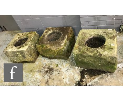 Three Derbyshire stone chimney pots or planter troughs of square form, each approximately 30-32cm high and 48cm square. (3) 