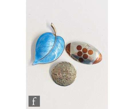A Norwegian silver  and blue enamelled brooch modelled as a leaf, with two Mexican brooches to include an oval copper and sil