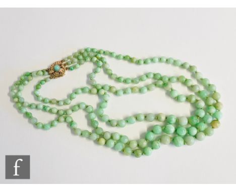 A triple graduated row of jade beads terminating in a  9ct hallmarked snap set with single bead, length 44cm, snap marked Bir