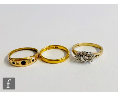 A 22ct wedding ring, weight 3g, with an 18ct five stone ring weight 2.4g and a 9ct diamond ring, weight 2.5g, all S/D. (3). 