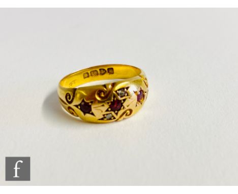 An 18ct hallmarked gypsy set ruby and diamond five stone ring to scroll shoulders, weight 2.8g, ring size L, Chester 1908. 