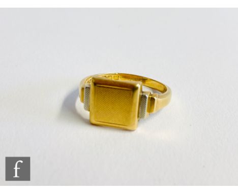 An 18ct yellow and white gold signet ring, engine turned decoration to square head and stepped shoulders, total weight 6.8g, 