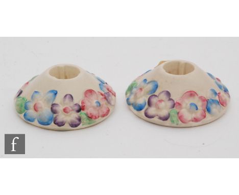 A pair of Clarice Cliff My Garden pattern candlesticks, each of compressed form with a band of hand painted moulded flowers, 