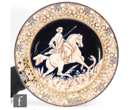 An early 20th Century charger in the manner of Zsolnay, decorated with a huntress upon her horse with a hissing serpent benea